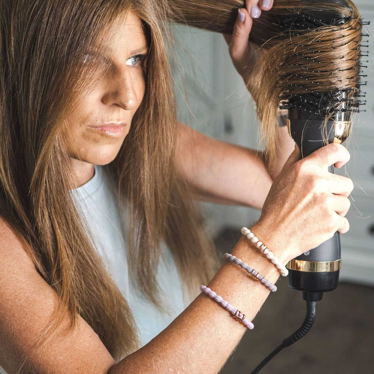 Jacynda Smith using TYME BlowBrush on her hair.
