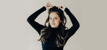 Woman with big TYME curls, black hair and high half pony