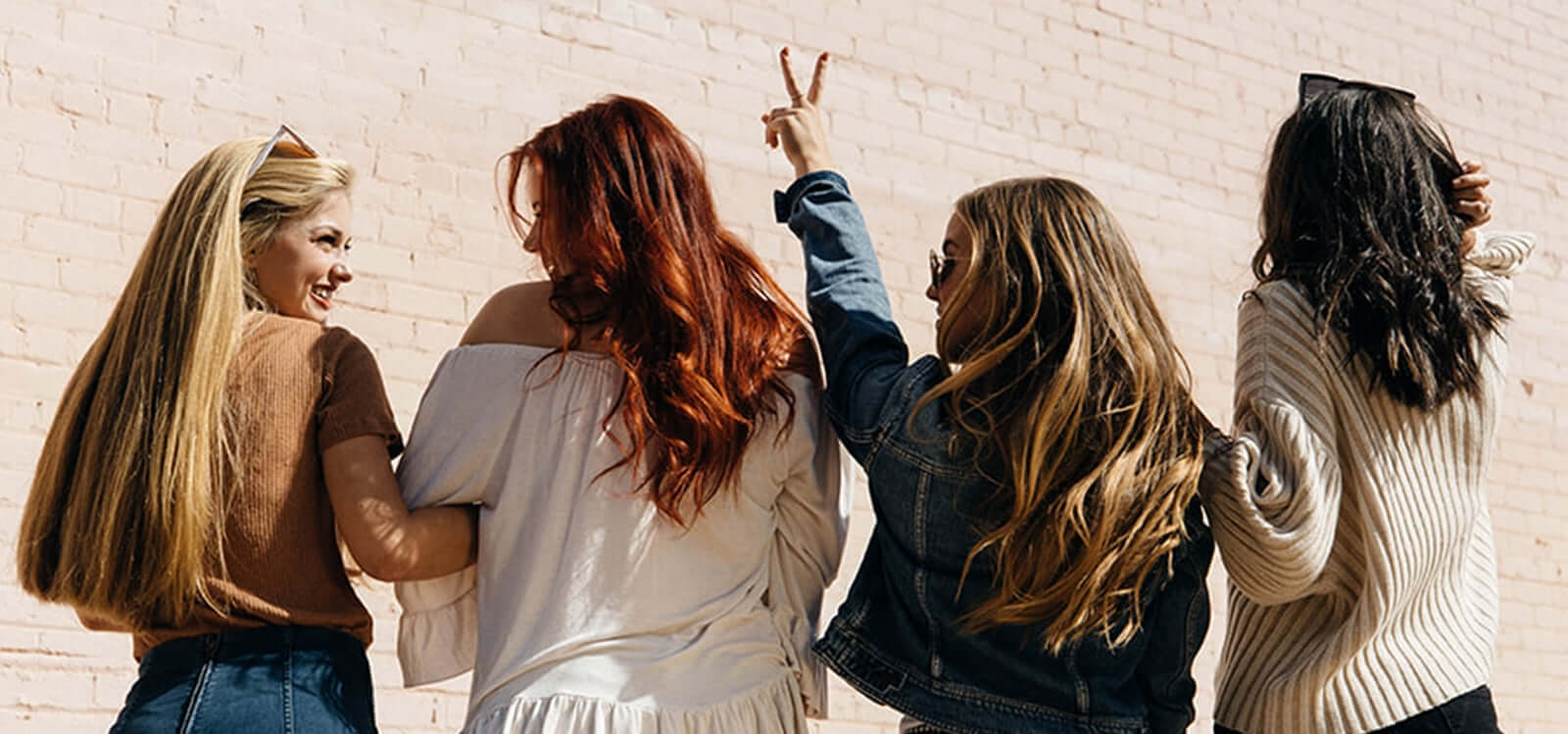 Lifetyme photo of 4 women-back of hair-1 girl piece sign