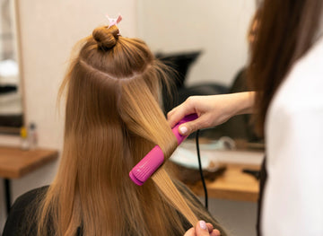Image of hair being curled with a flat iron.