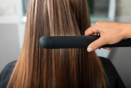 Image of fine, straight hair being flat ironed.