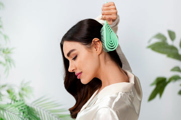 Image of a woman brushing her hair. 