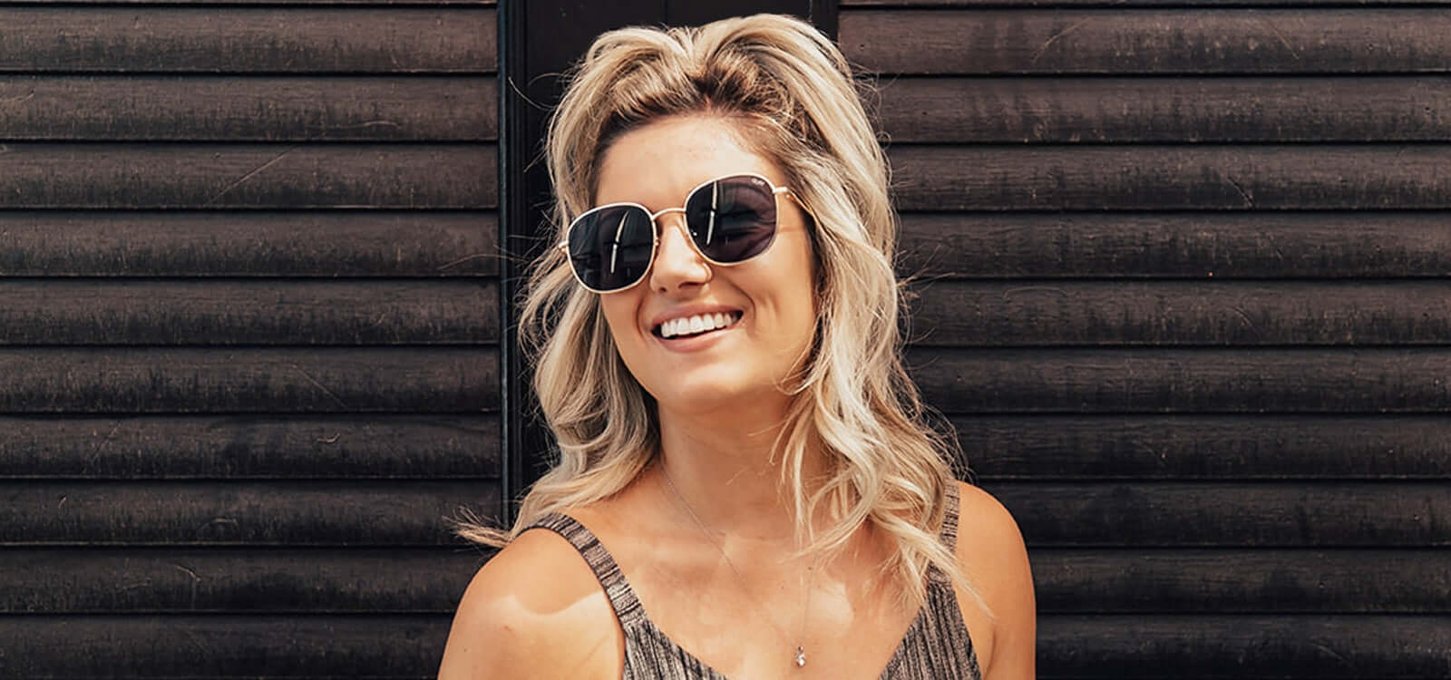 Blonde shorter hair with TYME curls and sunglasses