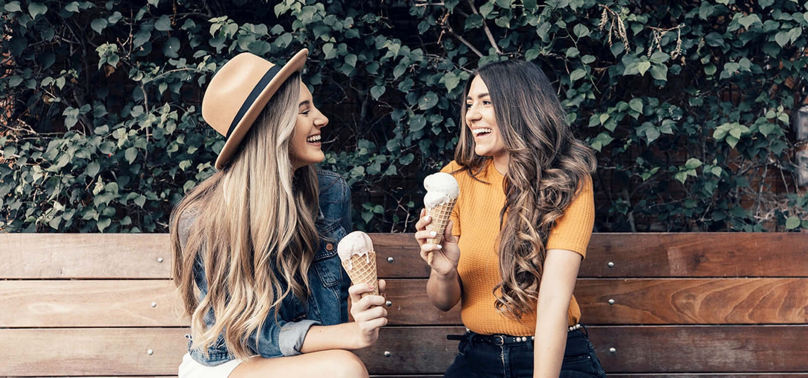 2 women sitting on a bench with ice cream and TYME curls