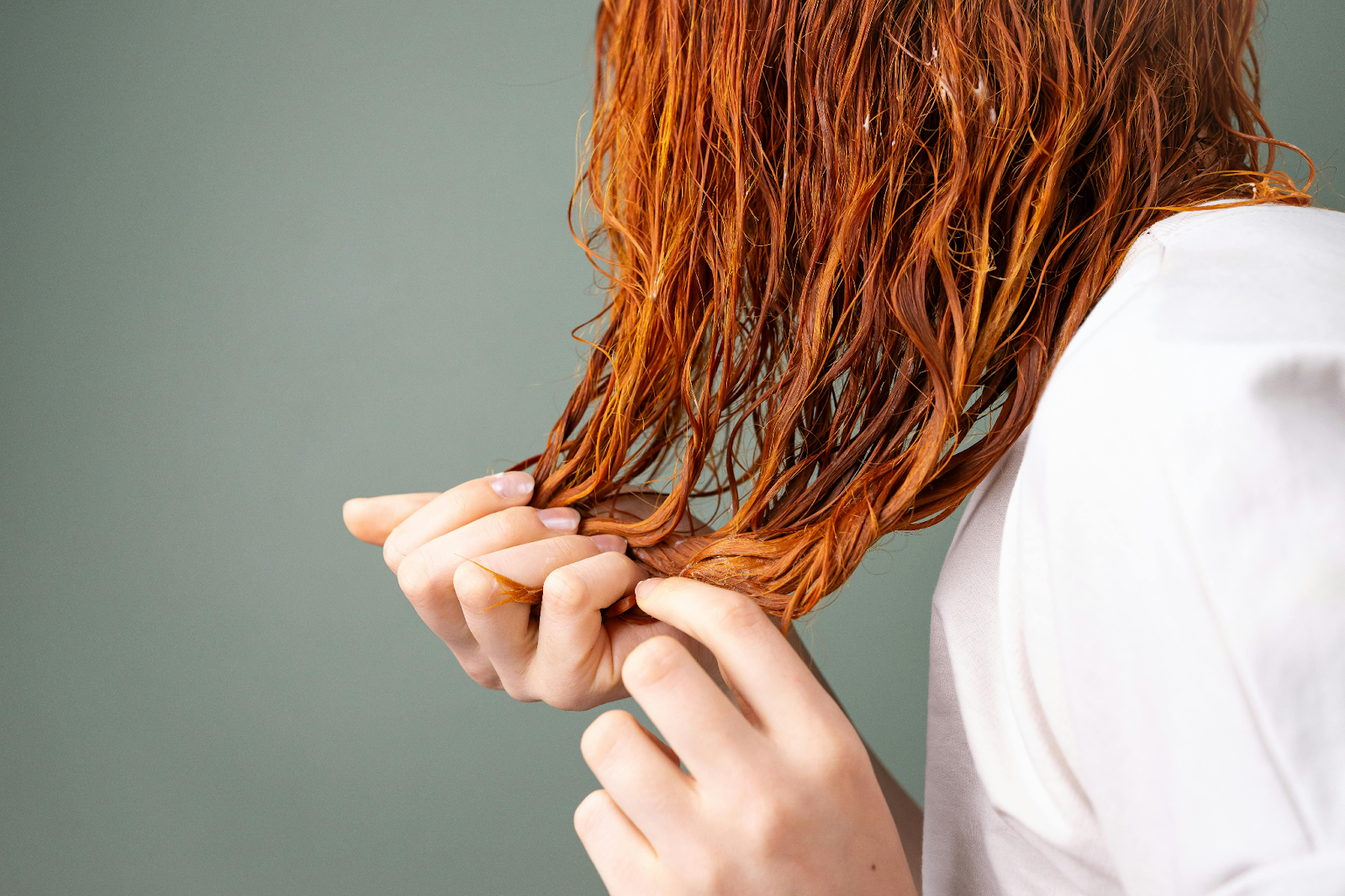 Image of a girl tousling her hair wet after showering.