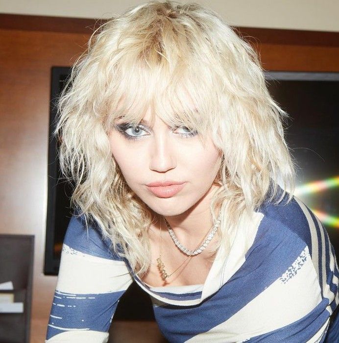 Image of Miley Cyrus with a blonde shag hairstyle.