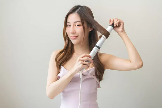 Woman curling her brown hair