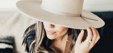 Woman wearing a creme hat 