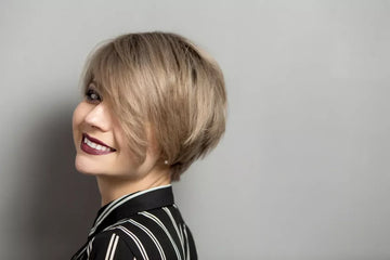 A young woman with a bixie haircut (pixie + bob elements).