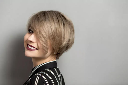 A young woman with a bixie haircut (pixie + bob elements).