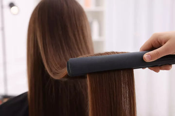 Someone flat ironing hair