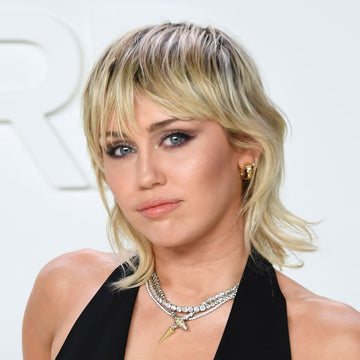 Image of Miley Cyrus with a mullet/wolf cut hybrid. 