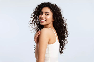 Smiling woman with thick black curly hair