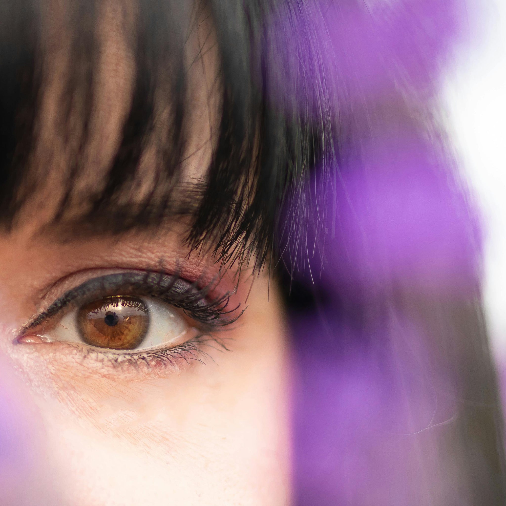 A zoomed-in shot of a young woman with black fringe bangs.