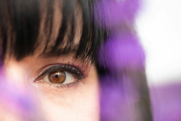 A zoomed-in shot of a young woman with black fringe bangs.
