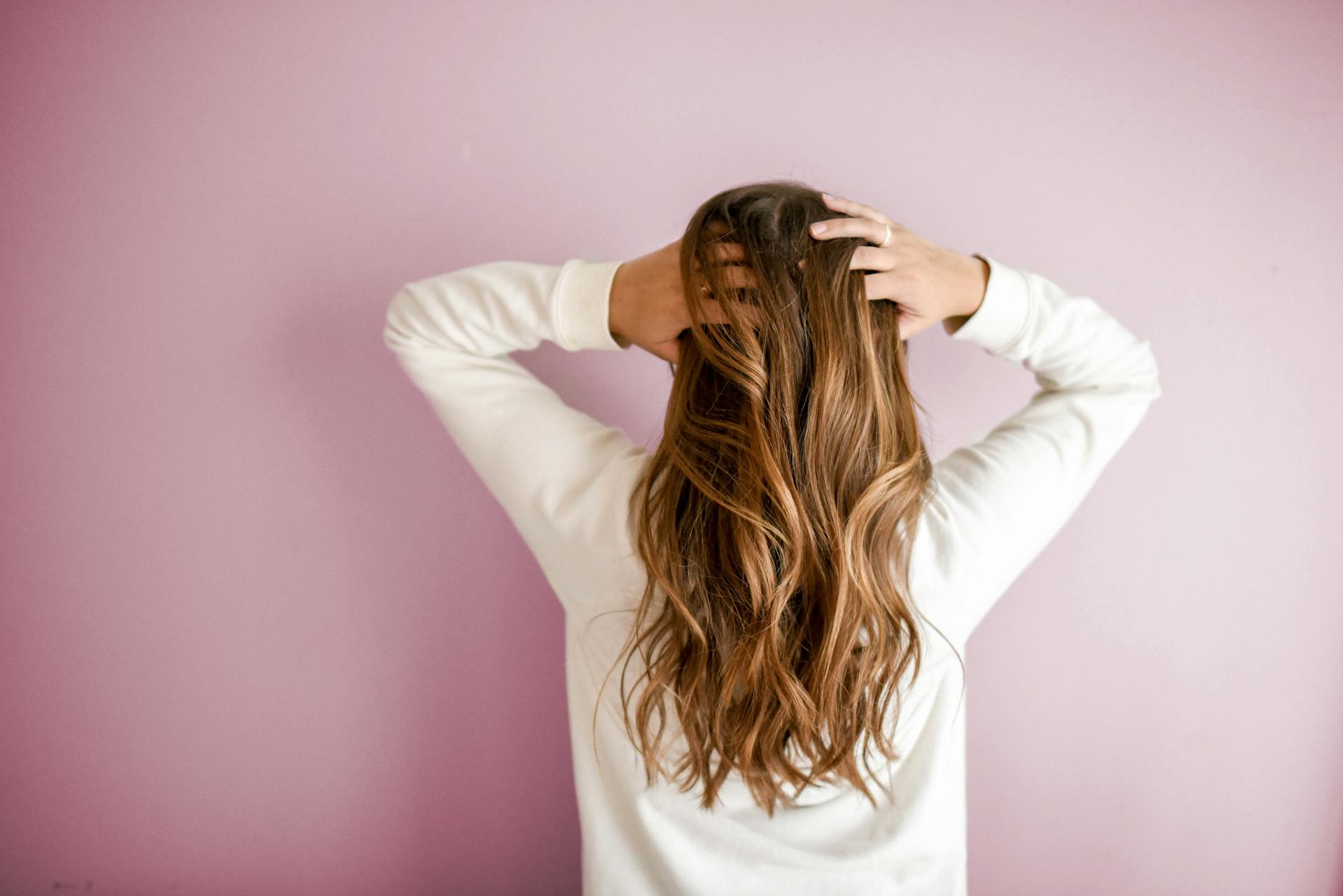 Image of the back of a woman’s head with brown hair.