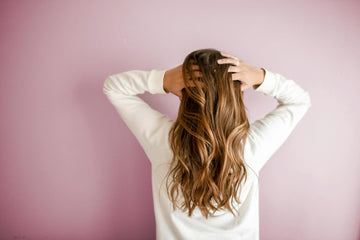 Image of the back of a woman’s head with brown hair.