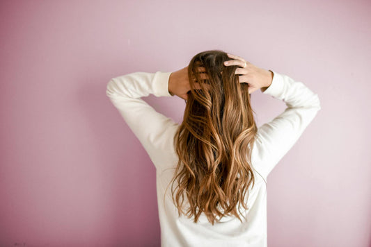 Image of the back of a woman’s head with brown hair.