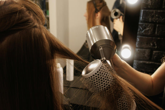A woman getting a salon blowout.