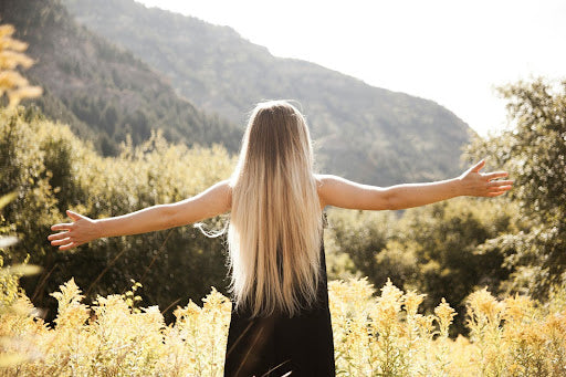 Woman with long, straight, frizz-free hair standing outside. Credit: Pexels, Brennan Tolman.