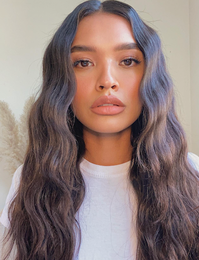 Image of a girl with long curled hair. 