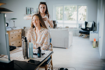 A woman with fine hair trialing the best lightweight heat protectant for fine hair.