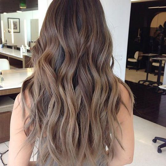 The back of a woman with styled mushroom brown hair.