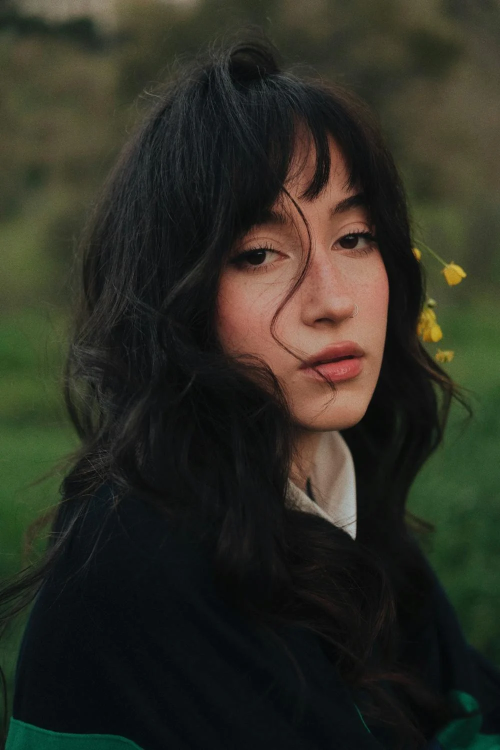 Image of a girl with bangs looking into the camera. 