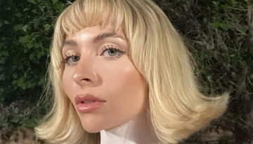 Image of a girl with voluminous blonde hair with flicked out ends. 