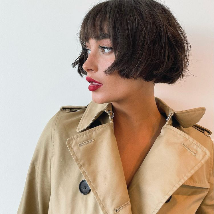 Image a woman with bangs and a french bob.