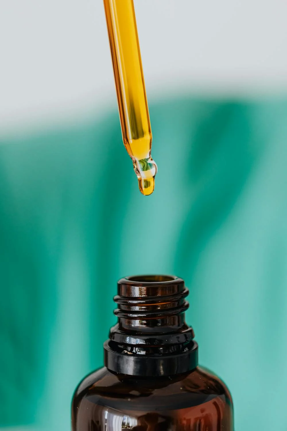 Image of a bottle and pipette of batana oil.