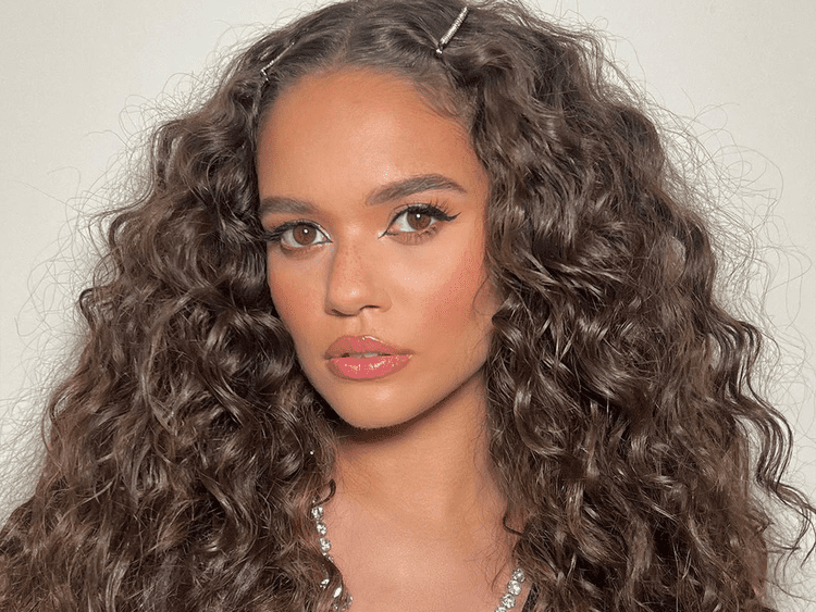 Image of @MADISONPETTIS with curly hair.