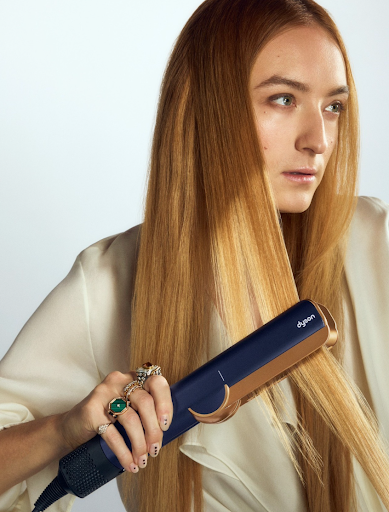 Image of a woman using a Dyson airstrait.
