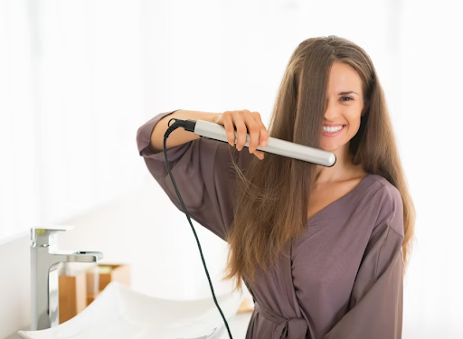 Image of a curl straightening her hair.