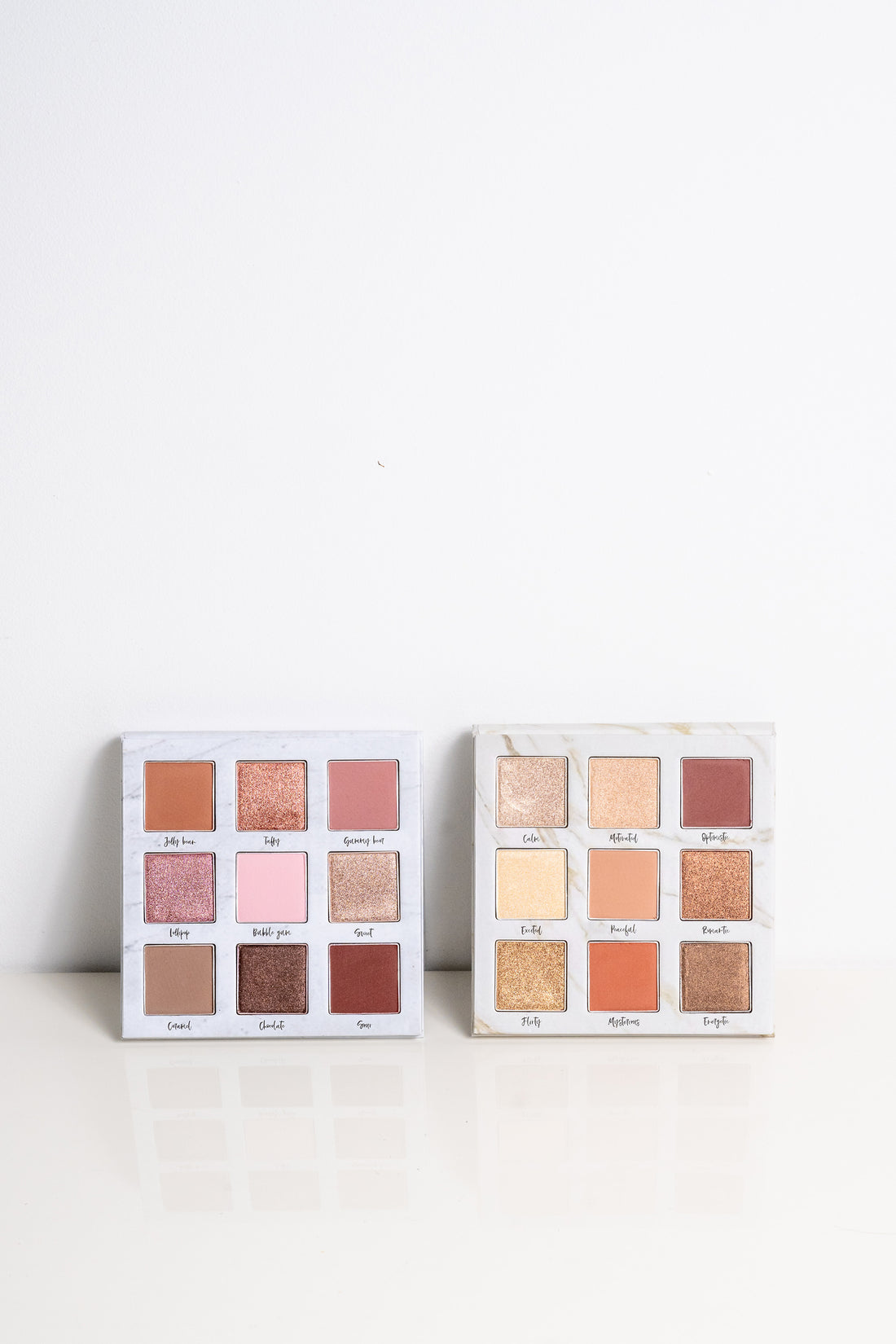 Lauren Ashtyn "eye candy" pressed powder eye shadow palette next to the "mood" eye shadow palette. 