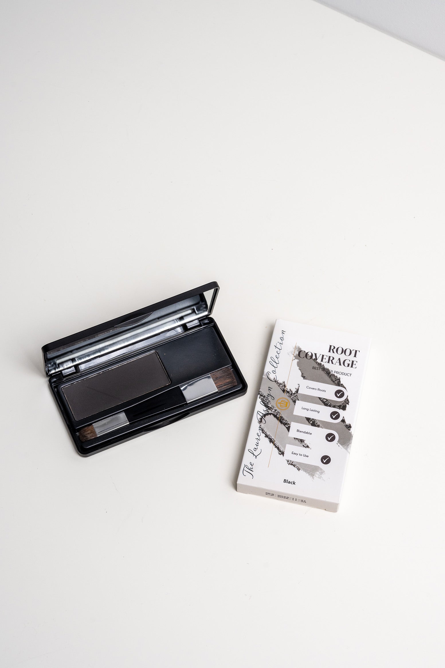 Open palette of black root coverage powder by Lauren Ashtyn next to the box