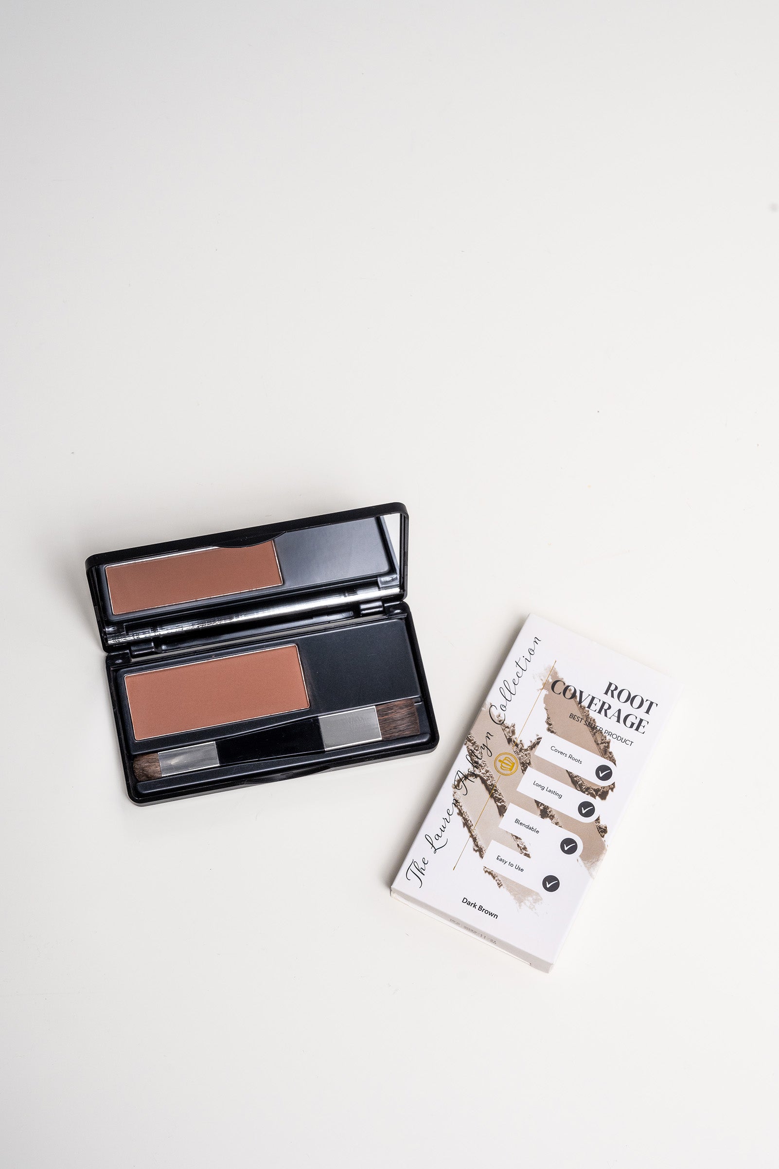 Open palette of dark brown root coverage powder by Lauren Ashtyn next to the box