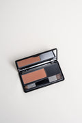 Open palette of dark brown root coverage powder by Lauren Ashtyn with attached mirror and brush included