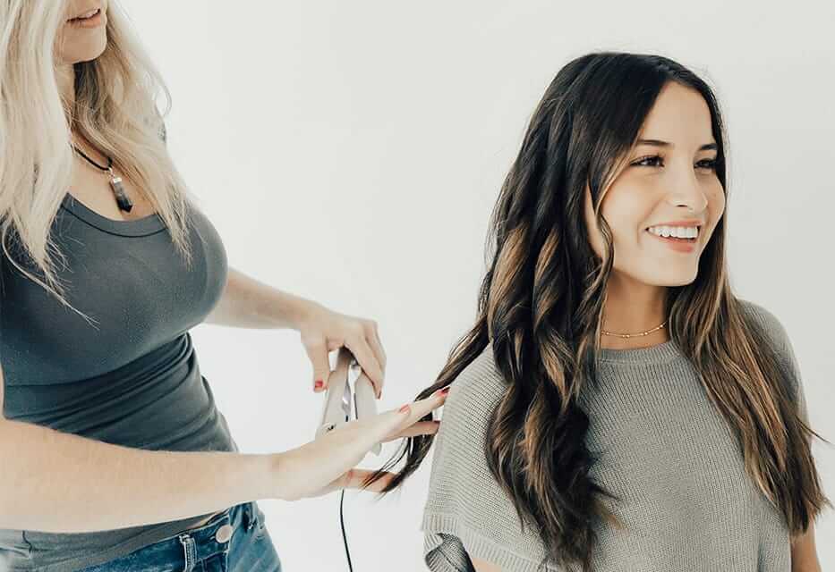 Curling hair with the TYME 2-in-1 curling iron.