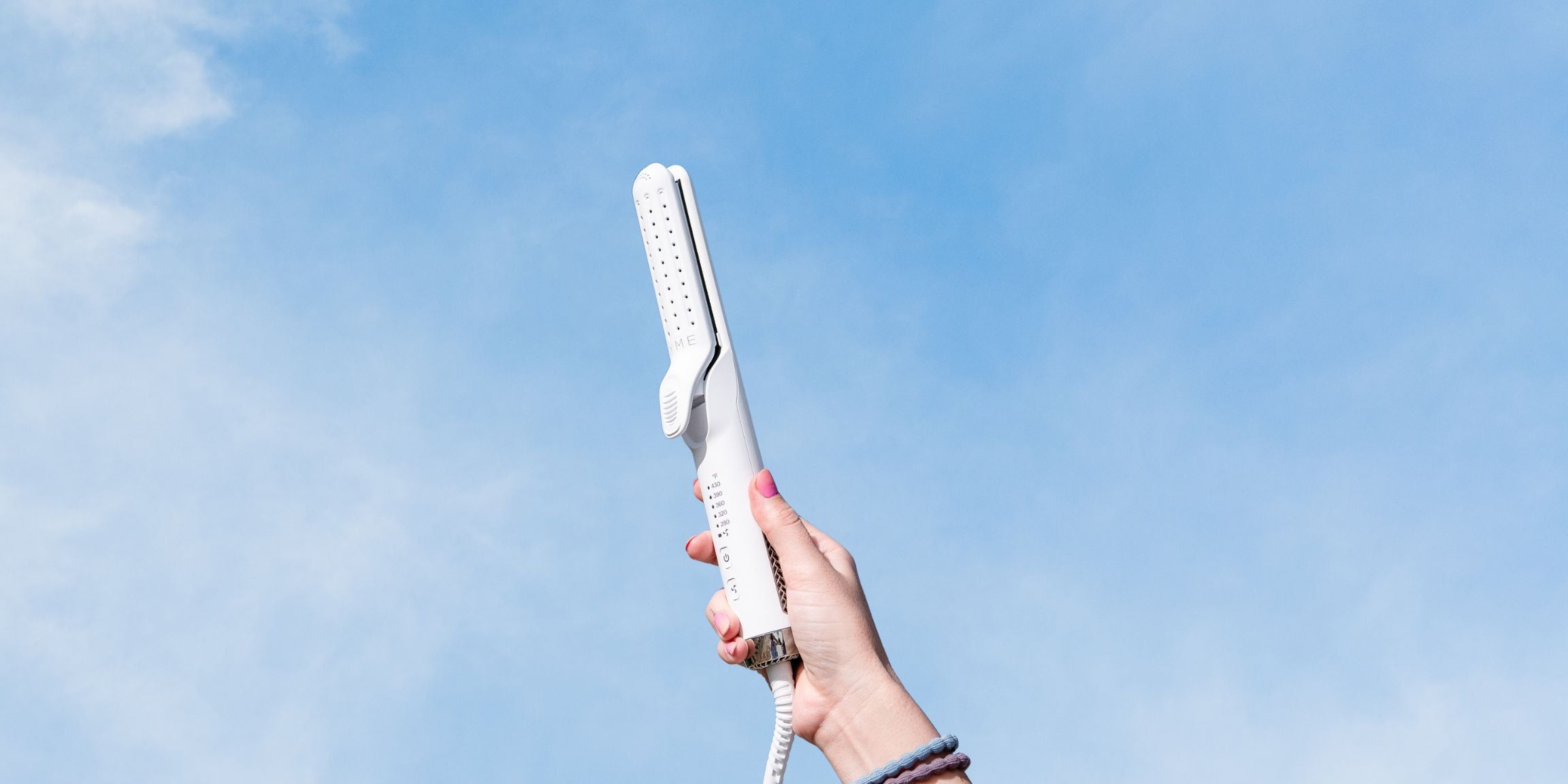 blue sky with a hand holding the tyme iron air