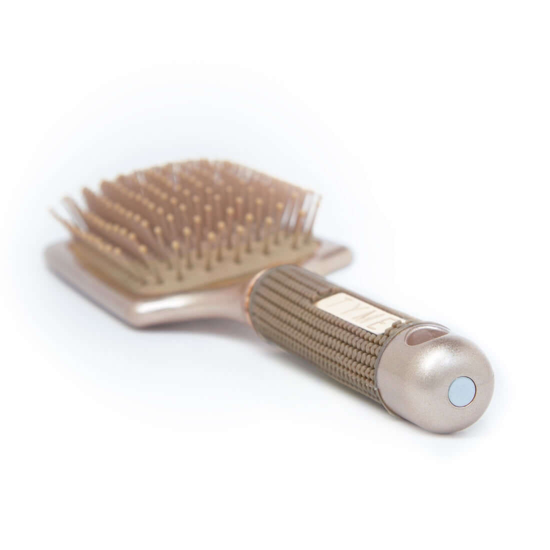 End of handle on TYME Paddle Hair Brush showing hole for hook storage and magnet for alternative storage.