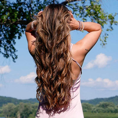 Long brown hair with waves after using the TYME Iron Air: Aura.