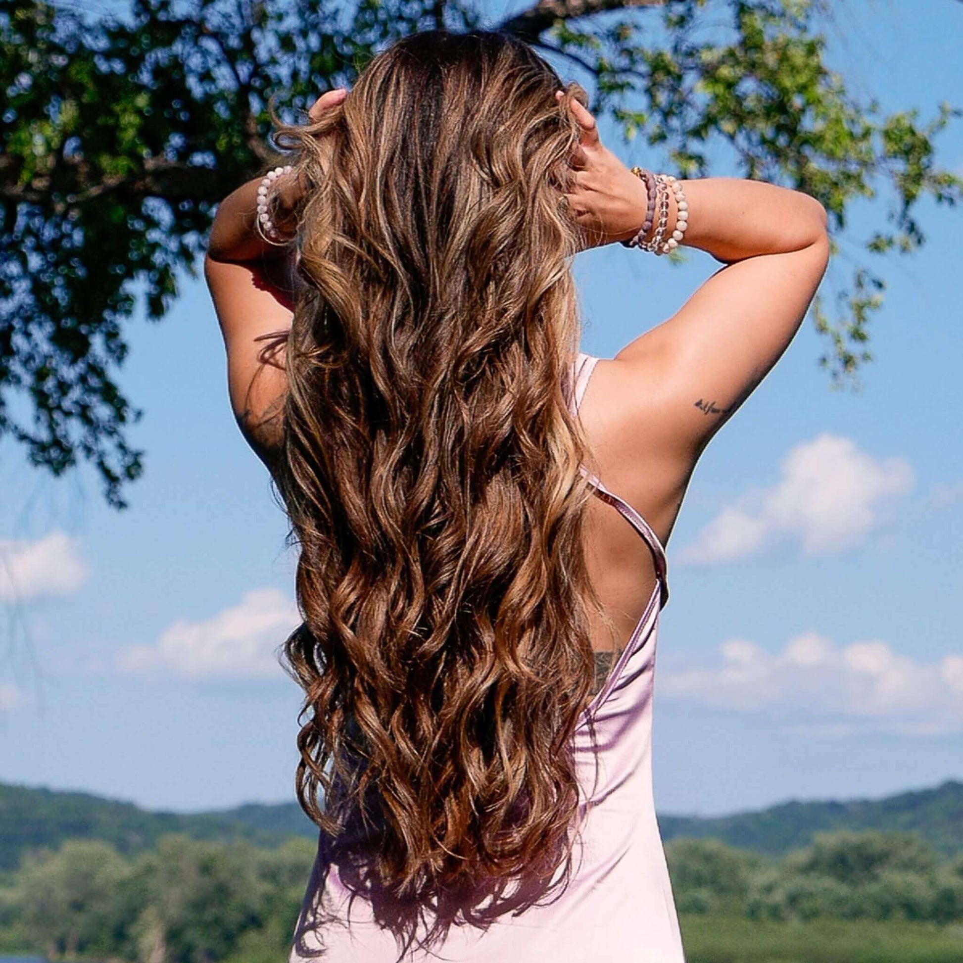 Woman with beautiful long hair curled by the TYME Iron Air.